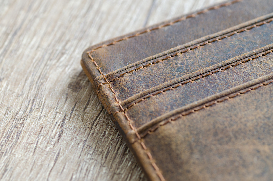 Leather wallet on wooden table